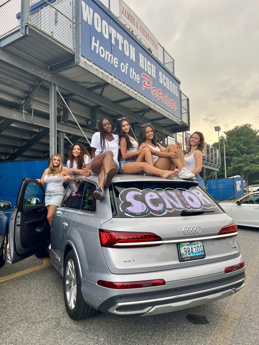 Seniors Zoi Bourazani, Roshali Nemaya, Gabriella Gberby, Alina Parikh, Ruth Bayou and Sophia Shapiro showcase their graduation-themed car decorations in front of the football stadium. Photo courtesy Gabriella Gberby