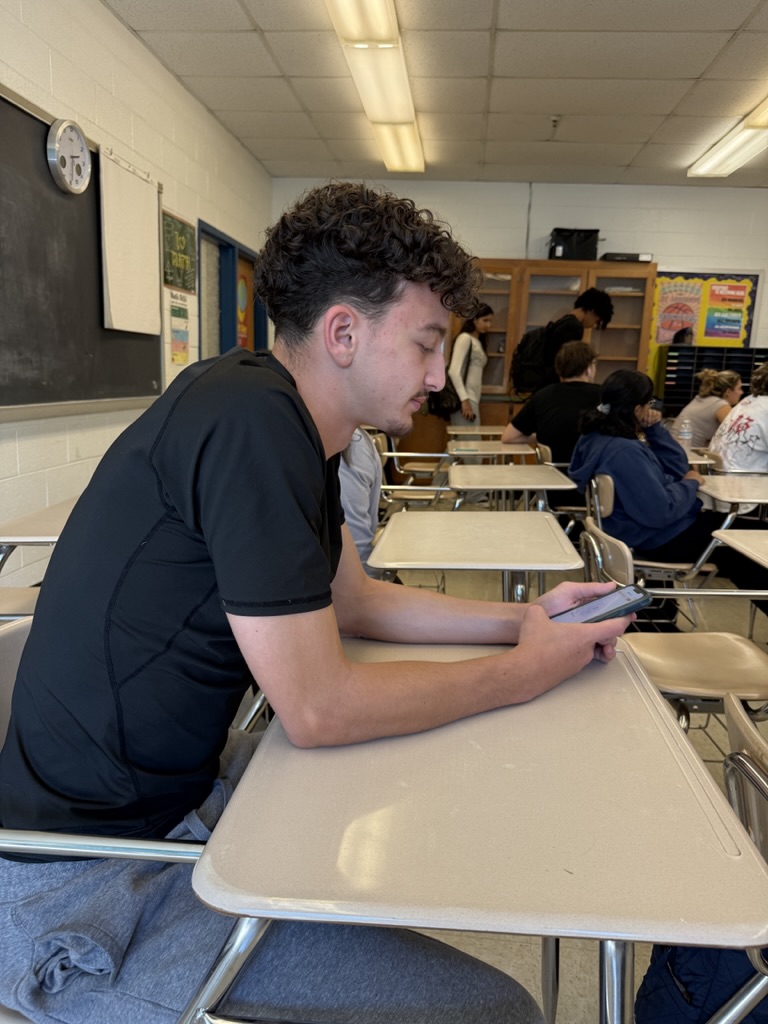 Junior Haim Mikowski is finally able to go on his phone after his eighth period after keeping it in his backpack all day, following the new MCPS technology policy.