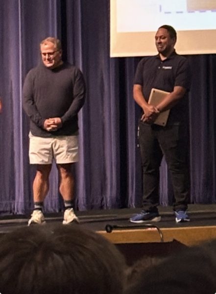 School counselors Robert Kurtz and Angelo Heflin introduce themselves to 11th and 12th grade students at the school's town hall on Sept. 10.