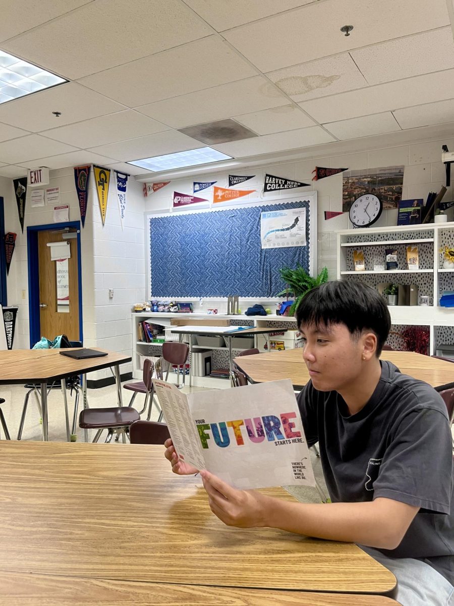Senior Ryan Shin reads an informational pamphlet about Boston University in the career center on Sep. 19. Boston University has chosen to remain test optional for applications  beginning in the fall of 2026. "If you have a good score, it can affect your application positively and give you an upper hand. In the same way if you don't have a good score, it doesn't harm you in any way," Shin said.