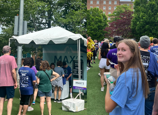 Max Alexander, the namesake of Max’s Best Ice Cream, scoops ice-cream at Max’s first pop up location at the Best Buddies annual friendship walk in May (left). Later, junior and Best Buddies member Skye Cushing participates in the walk while enjoying a scoop. “It’s vegan so I can eat it; I’m really excited to go to the Bethesda location soon,” Cushing said (right). Photos by Jilli Nalibotsky