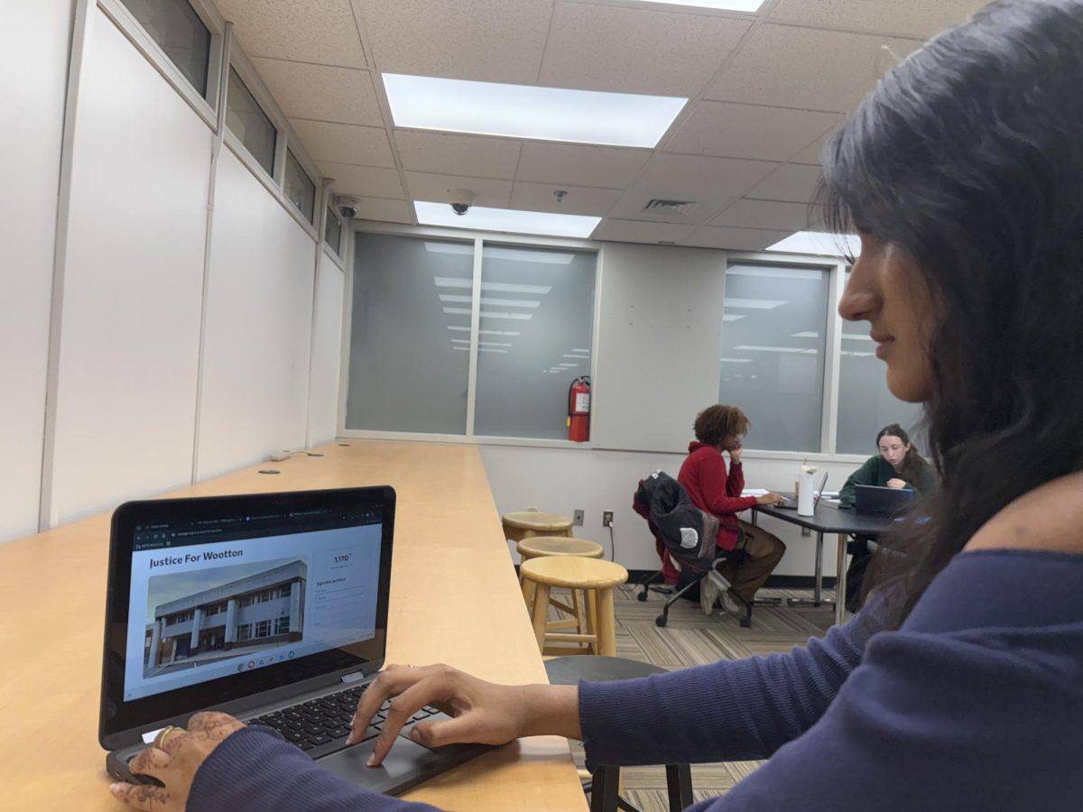 Junior class president Manasa Iyer signs the “Justice For Wootton” at the University of Maryland’s McKeldin Library on the AP Research field trip that took place on Oct. 28 ahead of the Board of Education public hearing later that day. Iyer was one of the five students rejected to testify at the public hearing “Being able to testify for our school makes it feel like I have a voice especially in these trying times when our school infrastructure is struggling and our students aren’t getting the resources they deserve. Being denied in the oral testimony after following all the guidelines is unacceptable and makes me feel like my voice is diminished,” Iyer said.