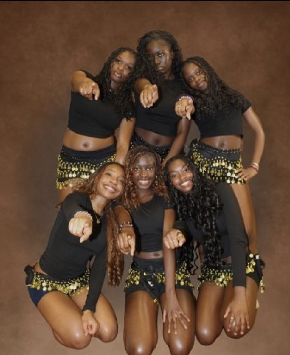 Afroelites prepare for their competition by taking a publicity photo in their performance outfits. "These outfits make me feel so confident and make me feel great while dancing," junior Maelyss Davi said.  Photo by Olive Nze