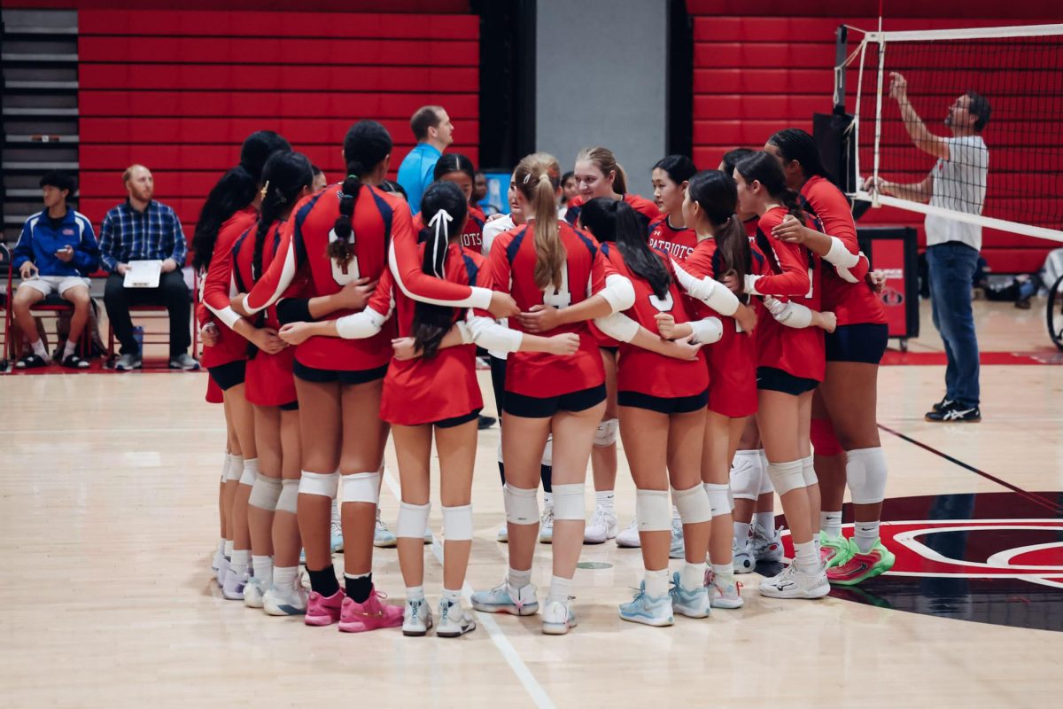 Varsity volleyball prepares before their game against Quince Orchard on Sept. 30. The game resulted in a nail-biting 3-2 win for the Patriots. Photo by Alison Wang of Maaven Media