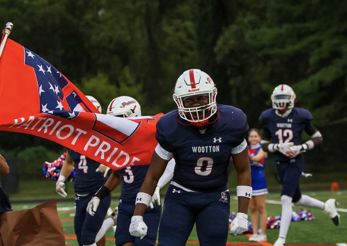Junior Captain Jude Ampofo takes the field with teammates for game against Walter Johnson Wildcats. Photo by Keon Gray