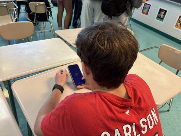 Sophomore Nathan Neeches plays fantasy football on his phone. Students join leagues with their friends to make football season more enjoyable. “I think fantasy football is fun because it makes you watch games and root for players you wouldn't normally watch," sophomore Jack Sisco said.