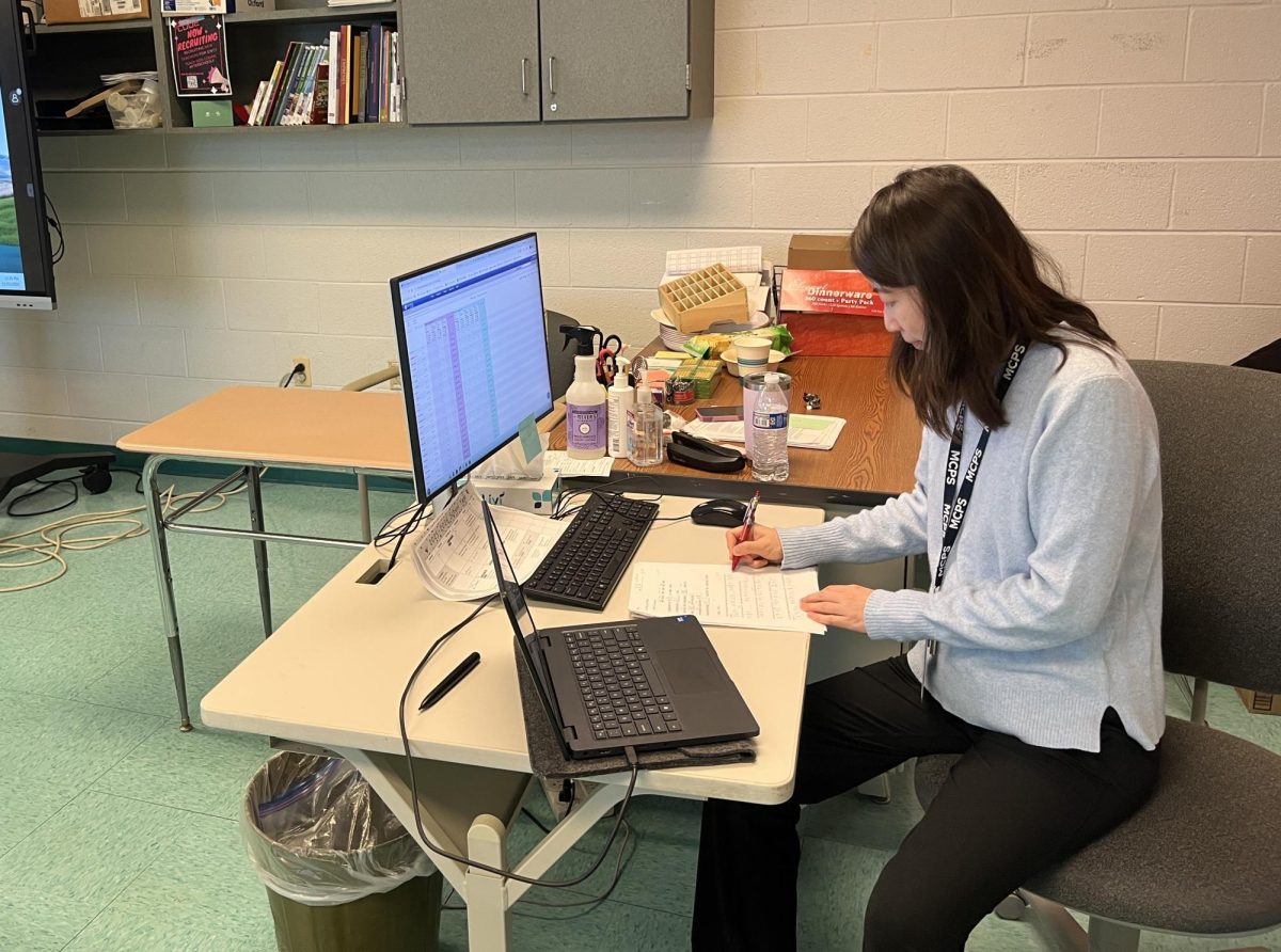 Language teacher Mintong Westcott grades students' work during her free sixth period on Nov. 21. Westcott said she has known she wanted to become an educator since she was young.