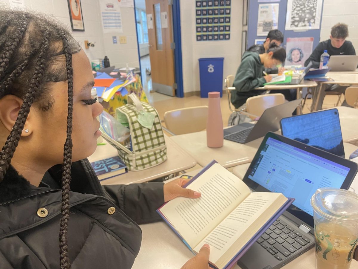 Senior Kirsten Sinkler chooses to use a paper copy of the novel "Exit West" instead of the online version provided for annotating the book. "I like using the paper copy of the book because it helps me focus better," Sinkler said.