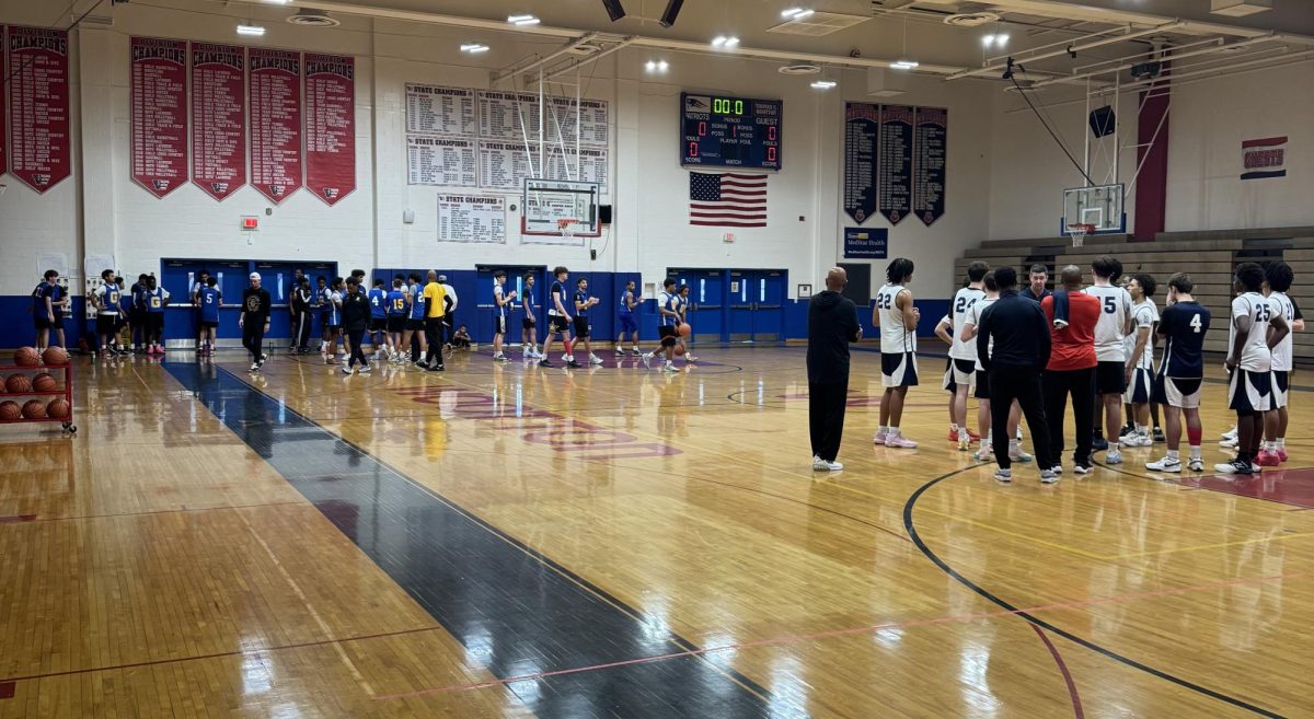 Boys' basketball talks as a team before beginning their joint practice with Gaithersburg on Nov. 22 in the main gym.