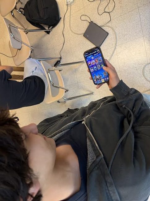 Sophomore Alexander Brennan plays Clash Royale in photography class on Dec. 16. "Class Royale decks are extremely unbalanced, and some are way too powerful," Brennan said.