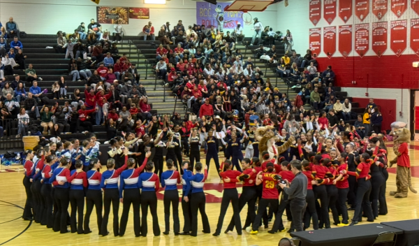 Division two Poms teams gather at the center of the gym for a dance circle while awaiting the reveal of awards. School mascots such as the Rockville Ram and the Bethesda-Chevy Chase Baron entered the dance circle, showing off their moves to the competing teams.