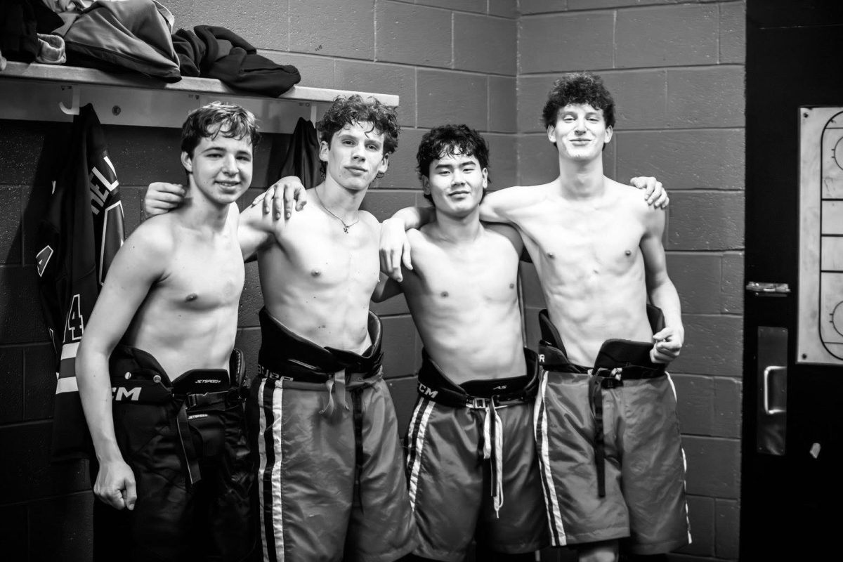 Junior Michael Klimantov, senior Justin Heller , junior Evan Batbold, and senior Owen Goozh in the locker room after being ejected from a hockey game against BCC. Despite their ejections, the team would go on to win the game 3-2. "Once they got ejected, the energy changed. Everyone was so determined to win," senior Yesh Tafa, who attended the game, said. Photo by Nick Cheng