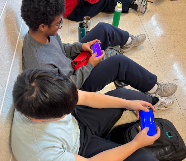 Seniors Carter Morton and Yesh Tafa play popular IOS video game Geometry Dash to pass time during lunch.