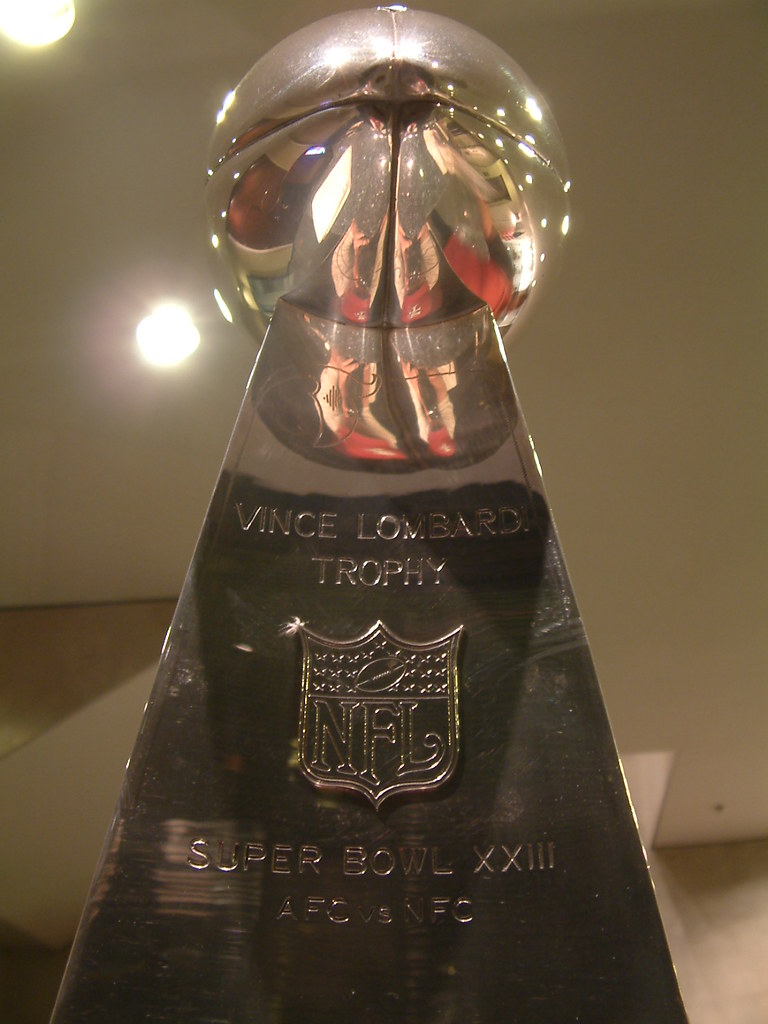 The Lombardi Trophy is awarded annually to the winner of the Super Bowl, the championship game of the NFL. It will be awarded to either the Seattle Seahawks or the New England Patriots in this year's Super Bowl LX matchup. "Lombardi Trophy 1" by youraddresshere is licensed under CC BY-SA 2.0.
