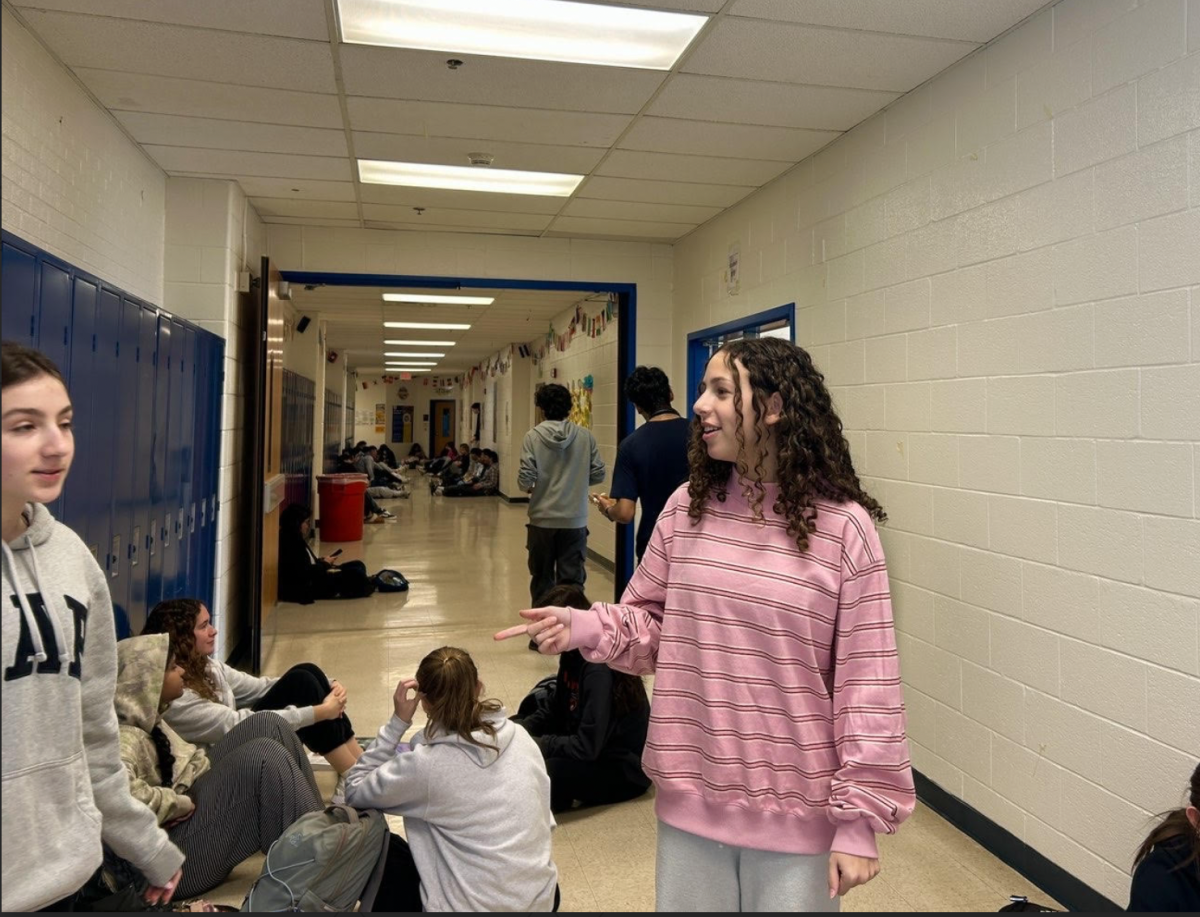Junior Dylan Neustadt wears a newly released pink striped Parke crewneck, which is part of their Valentine's Day collection that dropped on Jan. 27.