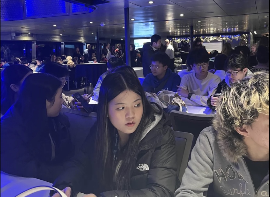 Juniors Surie Zhang and Elijah Liu gaze out the window of a dinner cruise on Lake Michigan during their Midwest Orchestra Chicago trip. The cruise offered scenic views of the city skyline, which they enjoyed together after eating from the buffet and taking photos for their Instagram posts.  “I enjoyed this trip, and the highlight was the cruise because of the view," Zhang said.