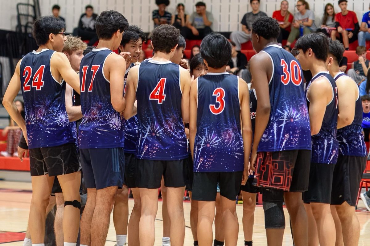 Last year's boys' volleyball team huddles up before going back into game play and winning the championship game against Churchill. Photo courtesy Wootton Athletics