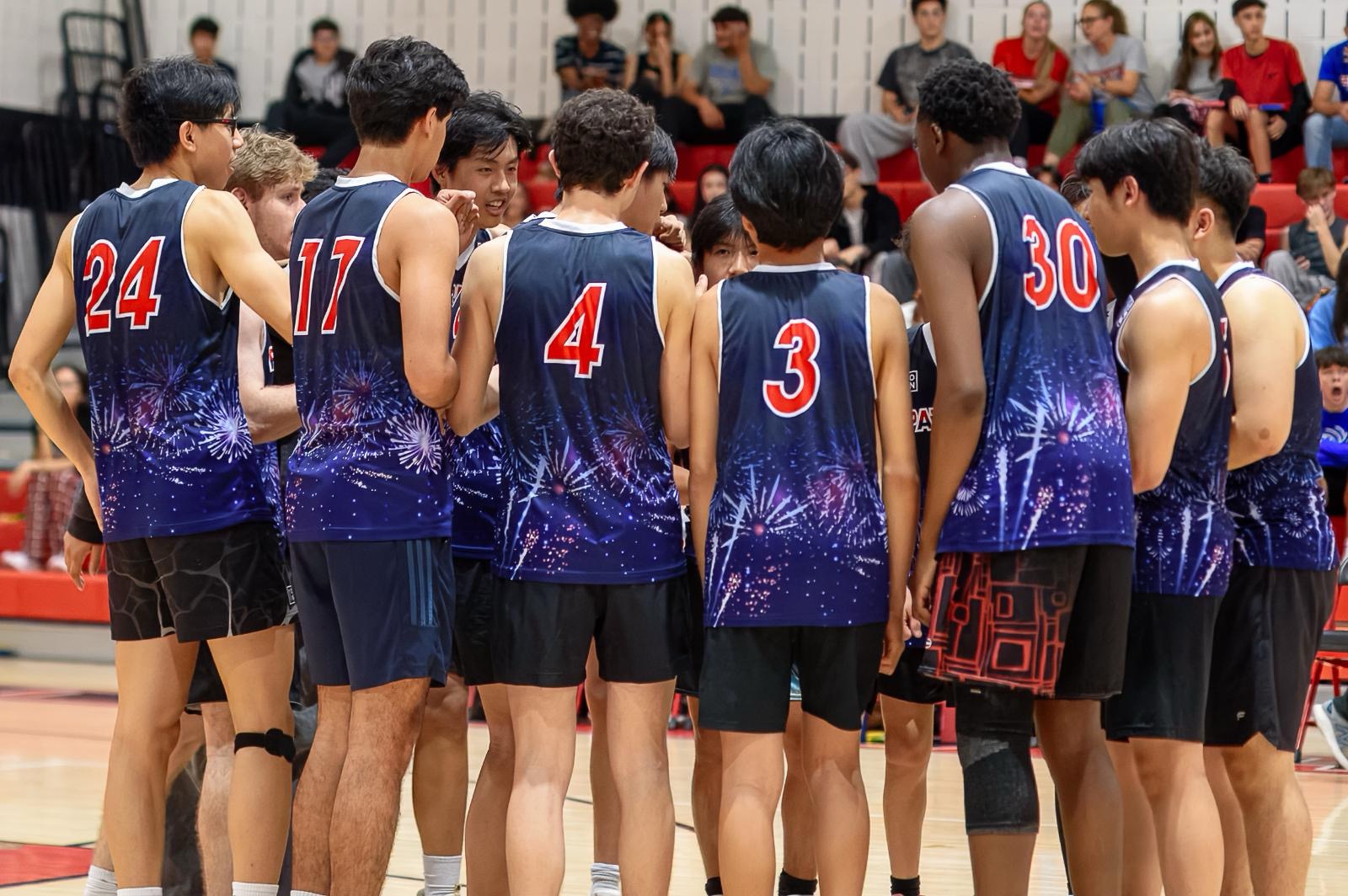 Last year's boys' volleyball team huddles up before going back into game play and winning the championship game against Churchill. Photo courtesy Wootton Athletics