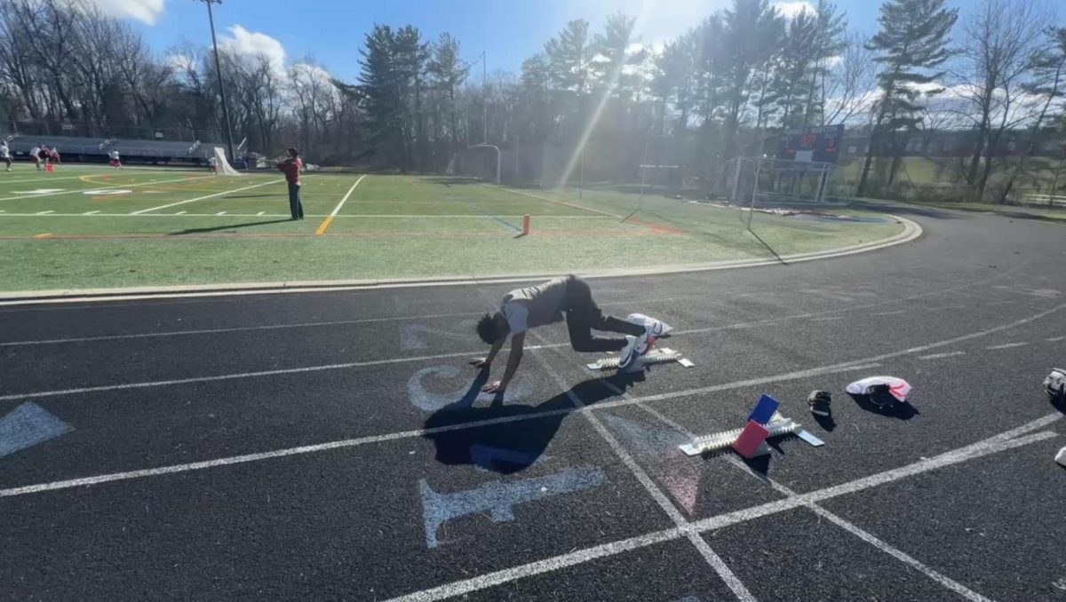 Junior Elijah Cullen practices sprint starts in practice on Monday, March 24. Photo by Bryson Filbert