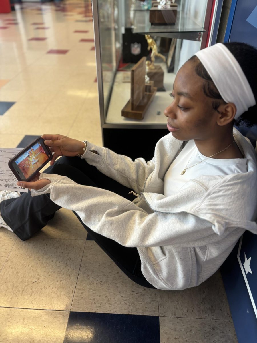 Freshman Serenity Sanni watches Temu Super Bowl commercial on her phone, on Feb 25. With the recent Super Bowl LX, people are talking more about the advertisements than the football game itself. “I love rewatching the advertisements, one because some of them are actually pretty entertaining and fun to watch, and two because I like to know what lots of companies are doing," Sanni said.