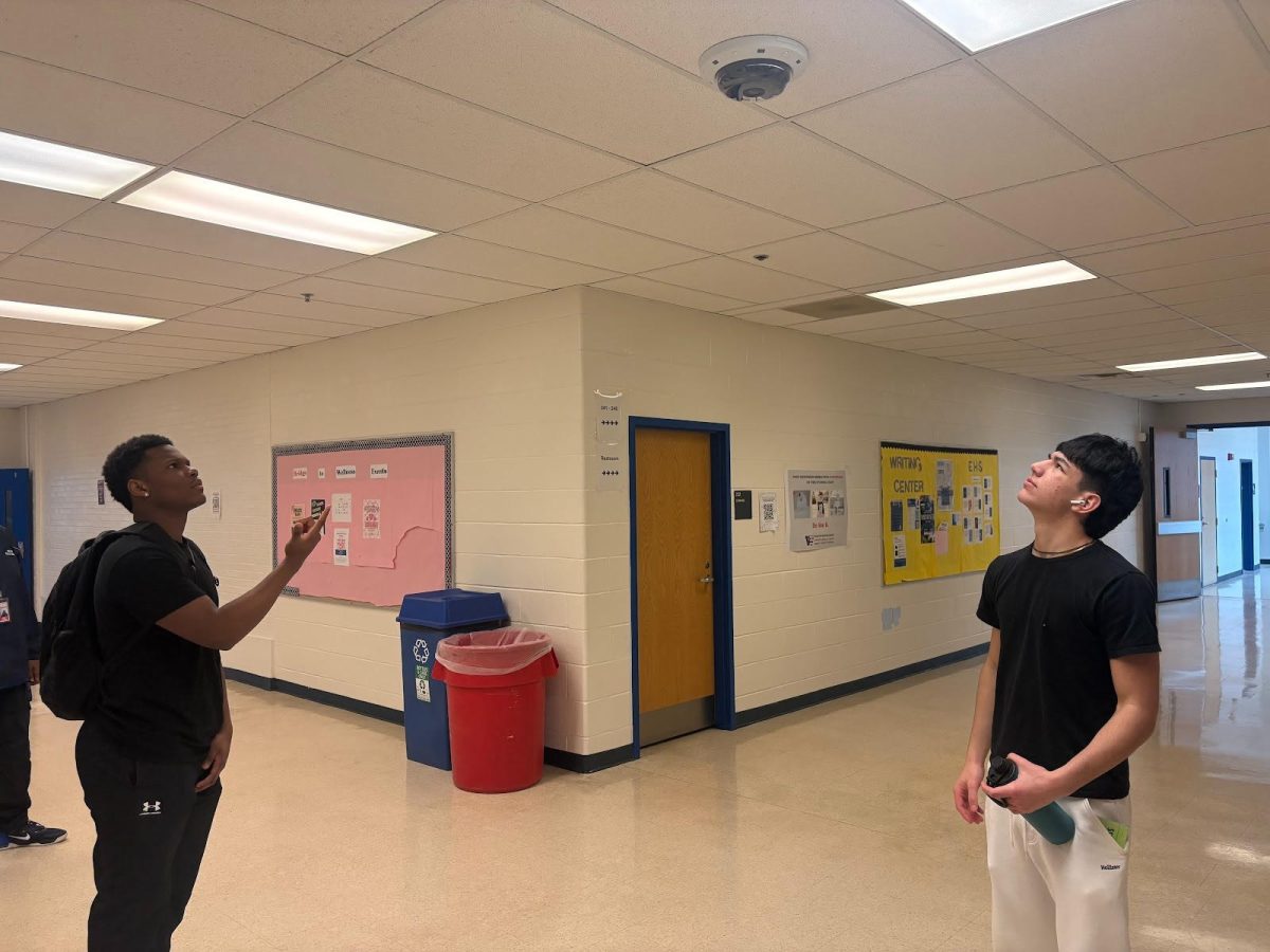 Senior Luisfer Avila Marquez and sophomore Alexander Pazartzis look at the new cameras on Feb. 29. Pazartzis later walked by several 360-degree cameras before getting to class just across the hall. Pazartzis said, “The increased amount of cameras made me feel uncomfortable because it gives us as students less privacy in our own school."