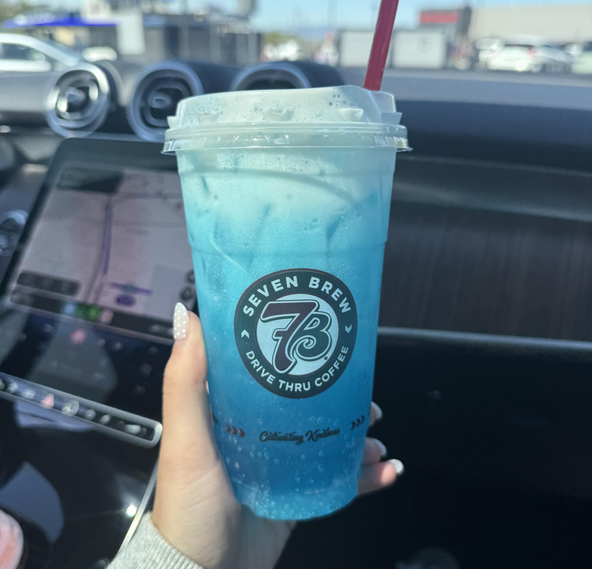 Junior Manu Poggio tries 7Brew for the first time, ordering a blue raspberry fizz with extra vanilla and cream. She had seen it all over her social media and was excited to try it. Poggio said, "I love the vibrate blue color of the drink." Photo by Manu Poggio