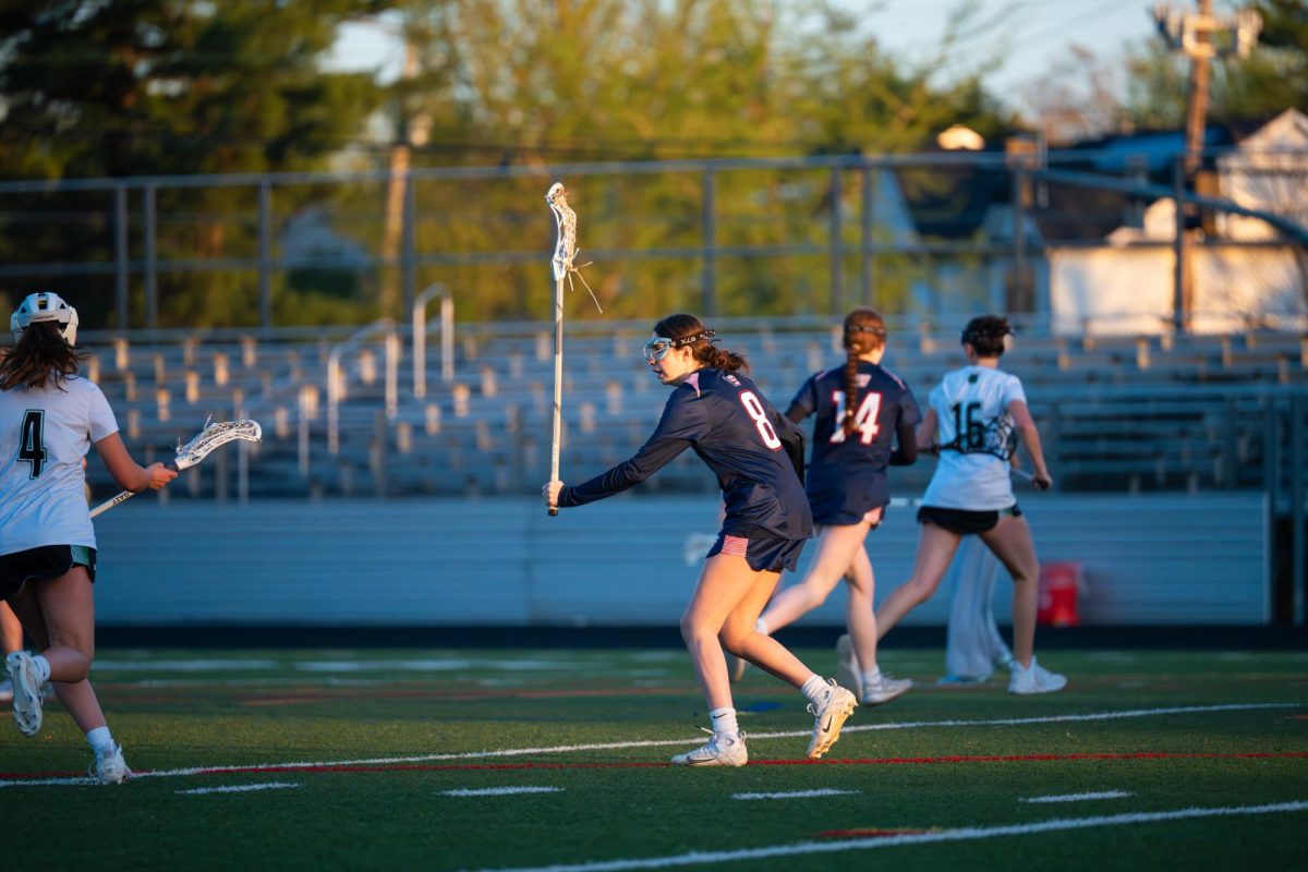 Senior Jenny Brailovsky plays defense in the girls' varsity lacrosse game against Walter Johnson on April 9. Photo by Edwin Lomotan