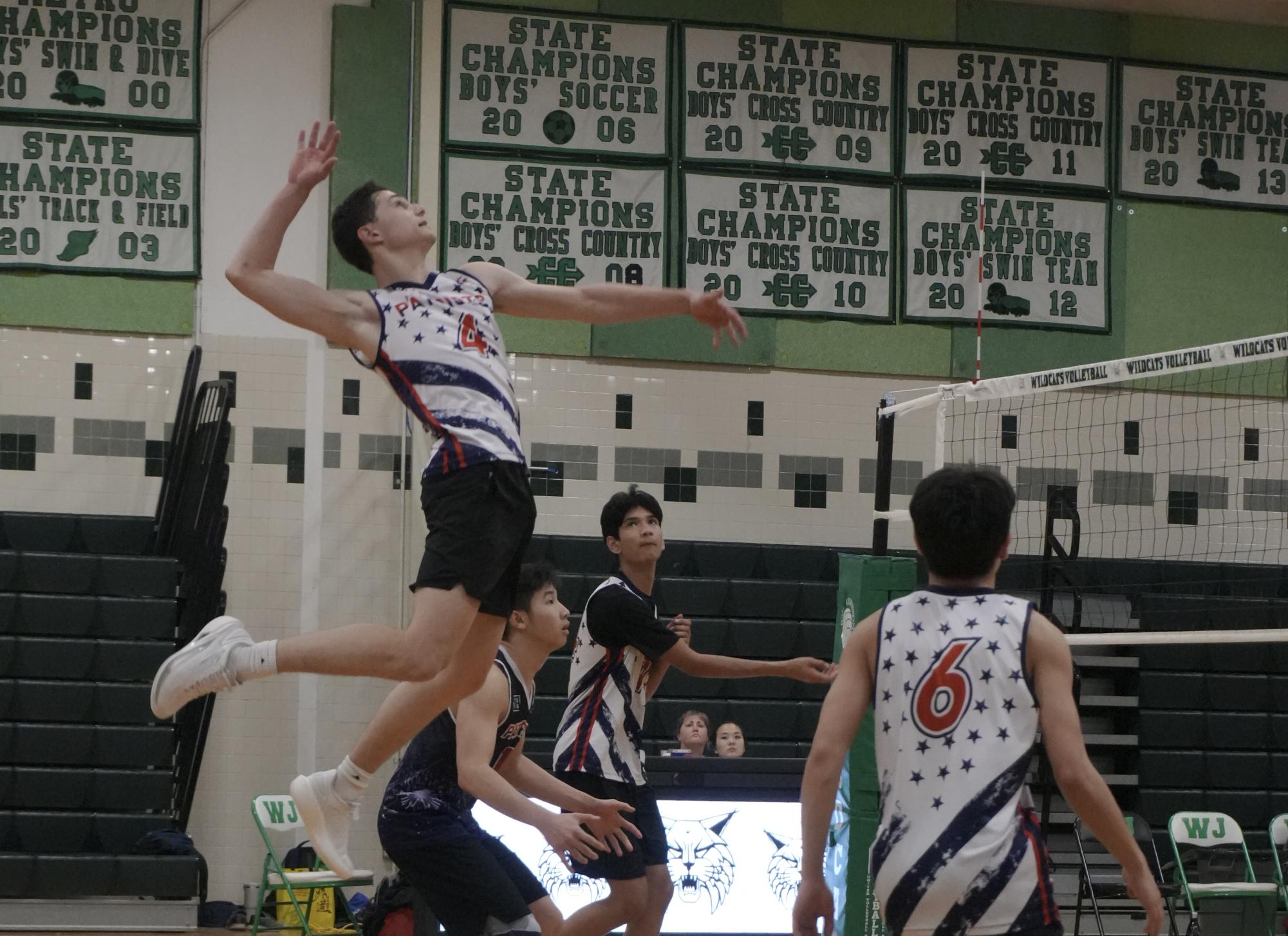 Senior Aaron Dubelman spikes the ball during the boys' volleyball team’s 3-2 win against Walter Johnson on April 14. “I personally love playing volleyball. It gives me the opportunity to relieve my stress by doing something I enjoy,” Dubelman said. Photo by Ayan Chowdhary