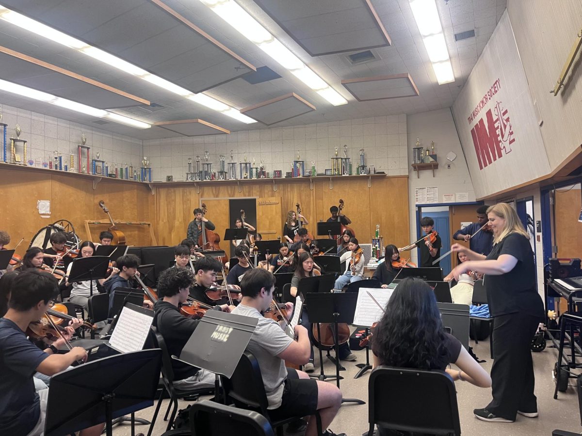 The orchestra rehearses the piece "Symphonic Dances" from "West Side Story," composed by Leonard Bernstein during seventh period. The students are playing their instruments and following Carolyn Herman, the conductor. “The piece is highly challenging and difficult in technique and rhythm. Dr. Eckerle and I hoped to pick a piece that is both challenging and fun to make the end-of-year concerts worthy and memorable,” Herman said.