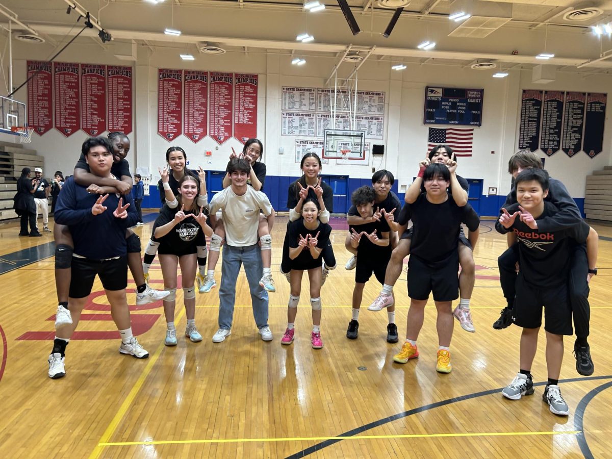 The volleyball team hypes themselves up before winning against Richard Montgomery 4-0 on March 10. During the game, freshman Felipe Machado saved the team from being scored on, which led to the 4-0 win. Photo by Yen Wang.