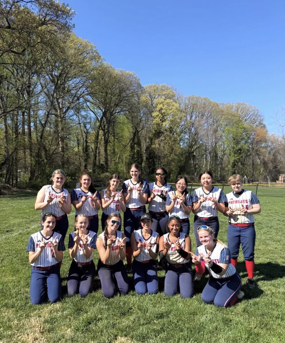 The varsity softball team holds up a W after their 15-1 win against Whitman on April 11. Photo courtesy  Wootton softball instagram