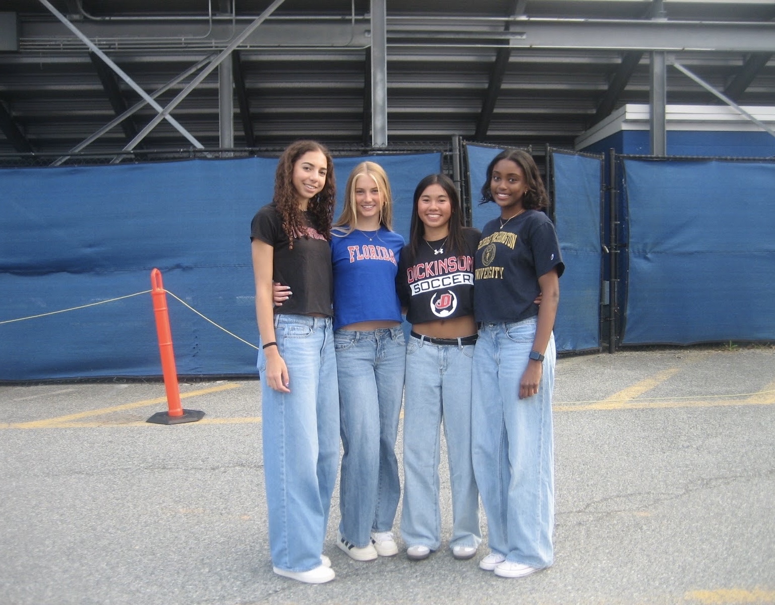 Seniors and best friends Maya Bellamy, Emory Scofield, Megan Lomotan and Helen Manolis (this writer) wear their college shirts to senior picnic on May 1. Bellamy will be playing lacrosse at Haverford College, Scofield will be studying journalism at the University of Florida, Lomotan will be playing soccer at Dickinson College and Manolis will be studying journalism at the George Washington University next year. Photo courtesy Megan Lomotan
