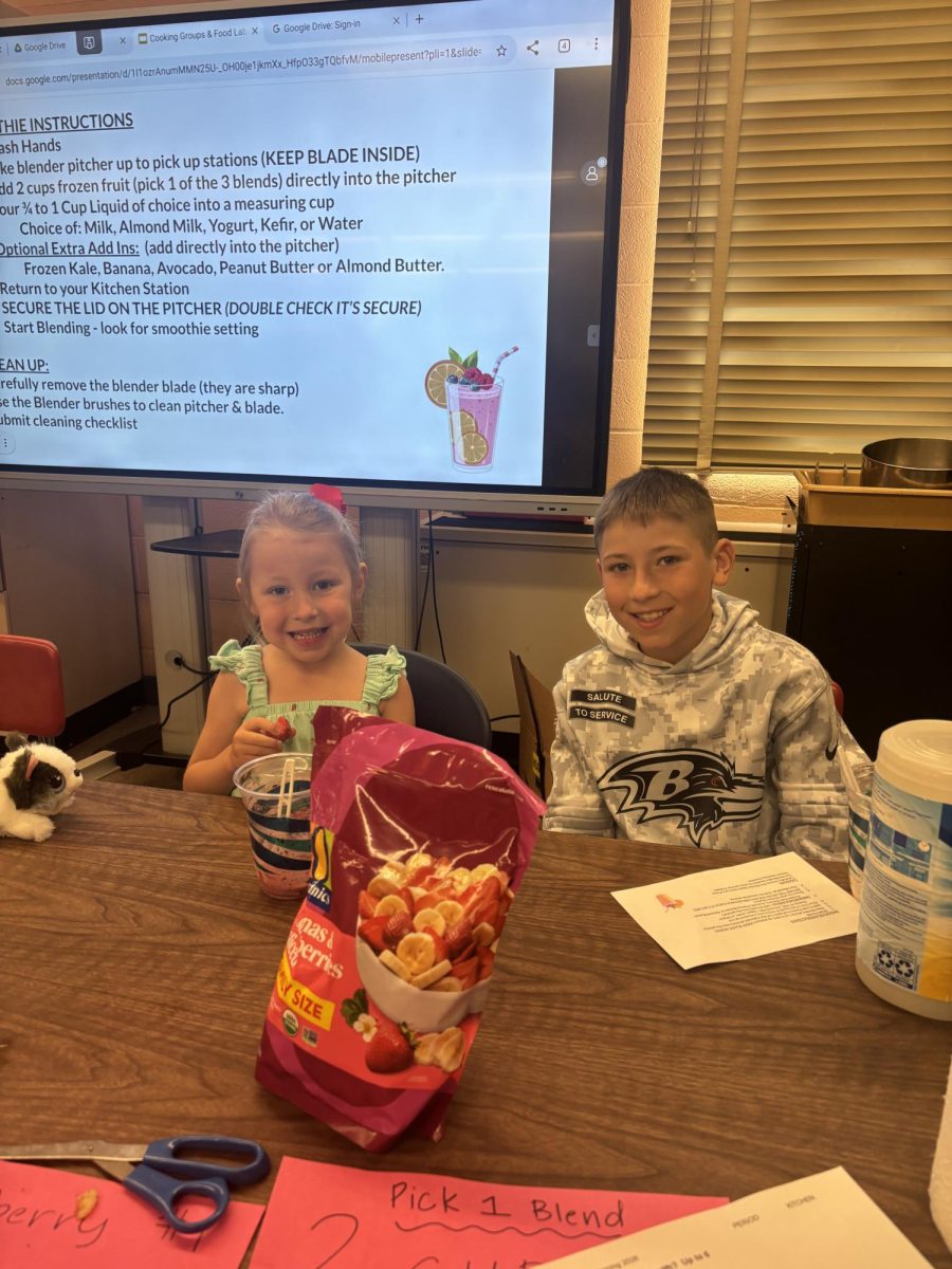 Nutrition teacher Kristen Daugherity's children, Navia and Chase, made smoothies on Take Your Child to Work Day. Kids were given options of fruit blends and ingredients.