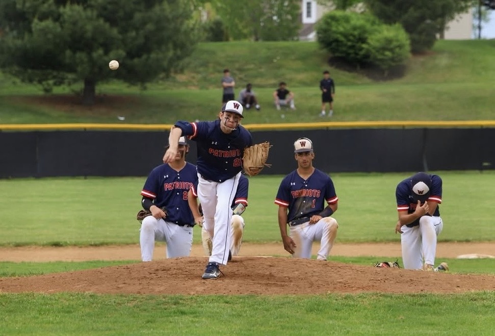 Senior Tanner Cornet practices before he begins pitching in regional semi final game against Magruder on May 9, where the team's season came to an end. Photo by Keon Gray.