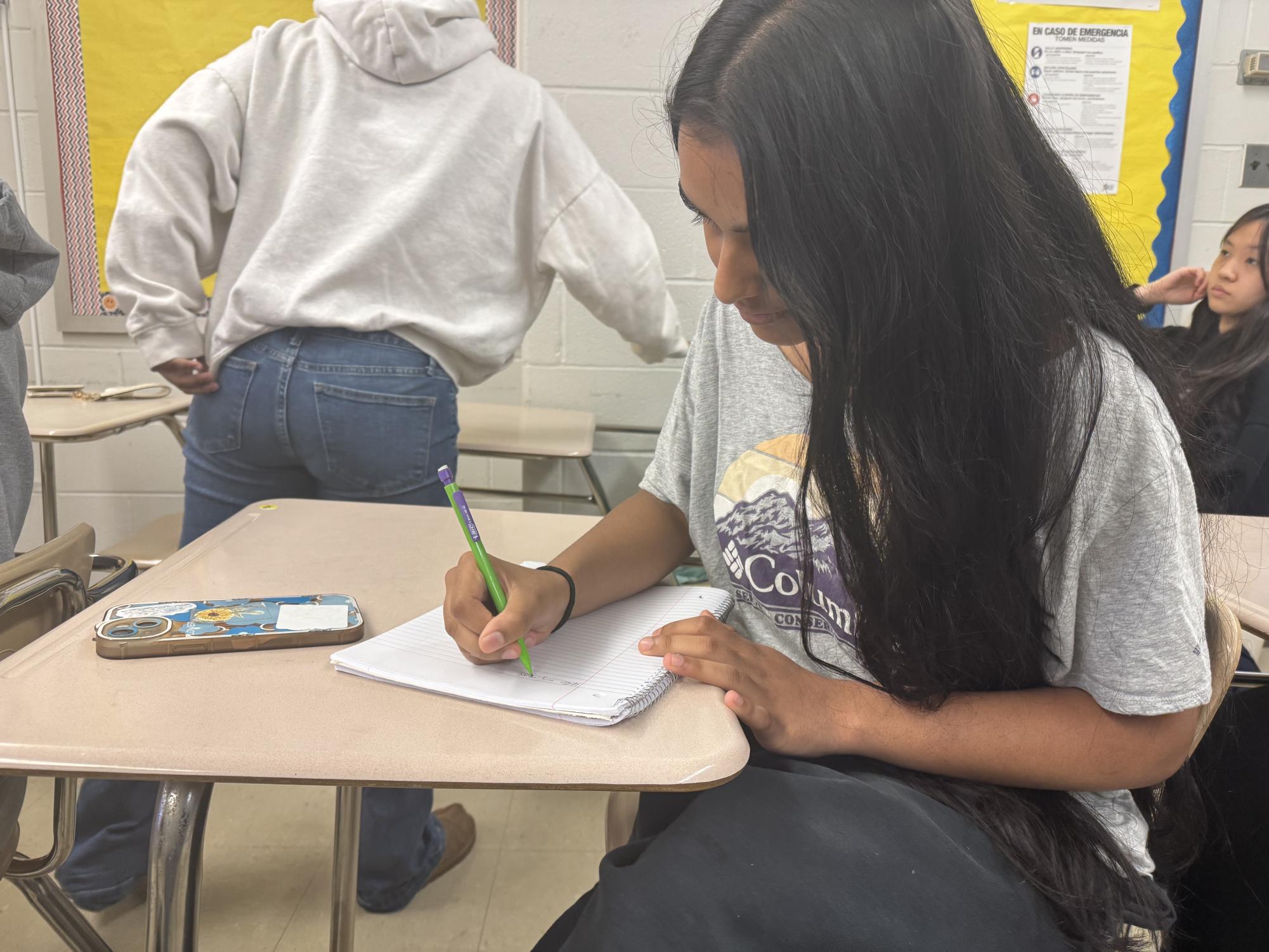 Sophomore Erina Shaik does a warm up for her precalculus class. The warm up helped her prepare for her math quiz she has the next day. "I really want to do well on the math quiz tomorrow, so I'm making an effort to study and learn as much as I can," Shaik said.