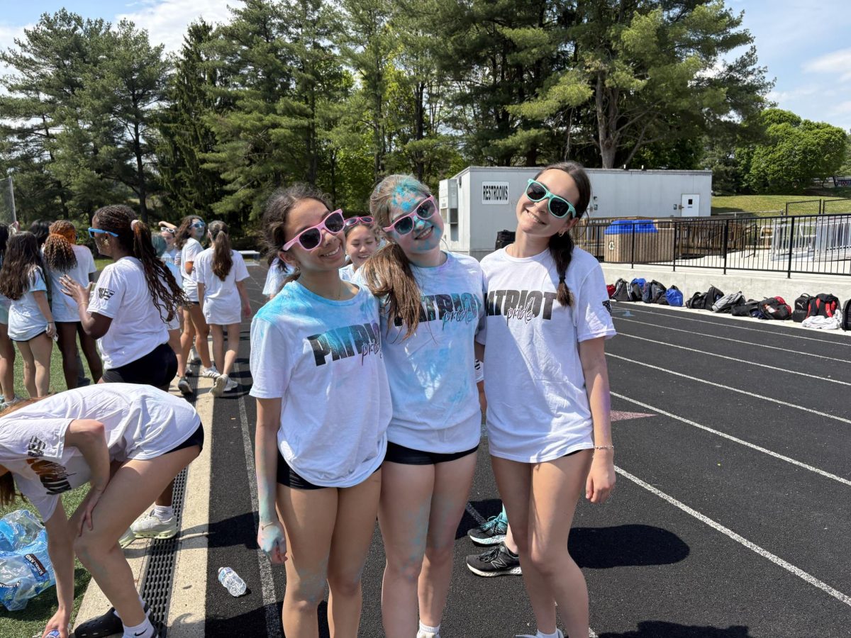 On April 23, students participate in the school event, the color run. The color run took place during the spring pep rally. Juniors Ashley Rudolph, Reya Kurup and Noa Lucas ran all around the school property and got covered in powder. "I had so much fun with my friends getting powder thrown at me and running with my friends," Lucas said. Photo by Jolie Ginsburg