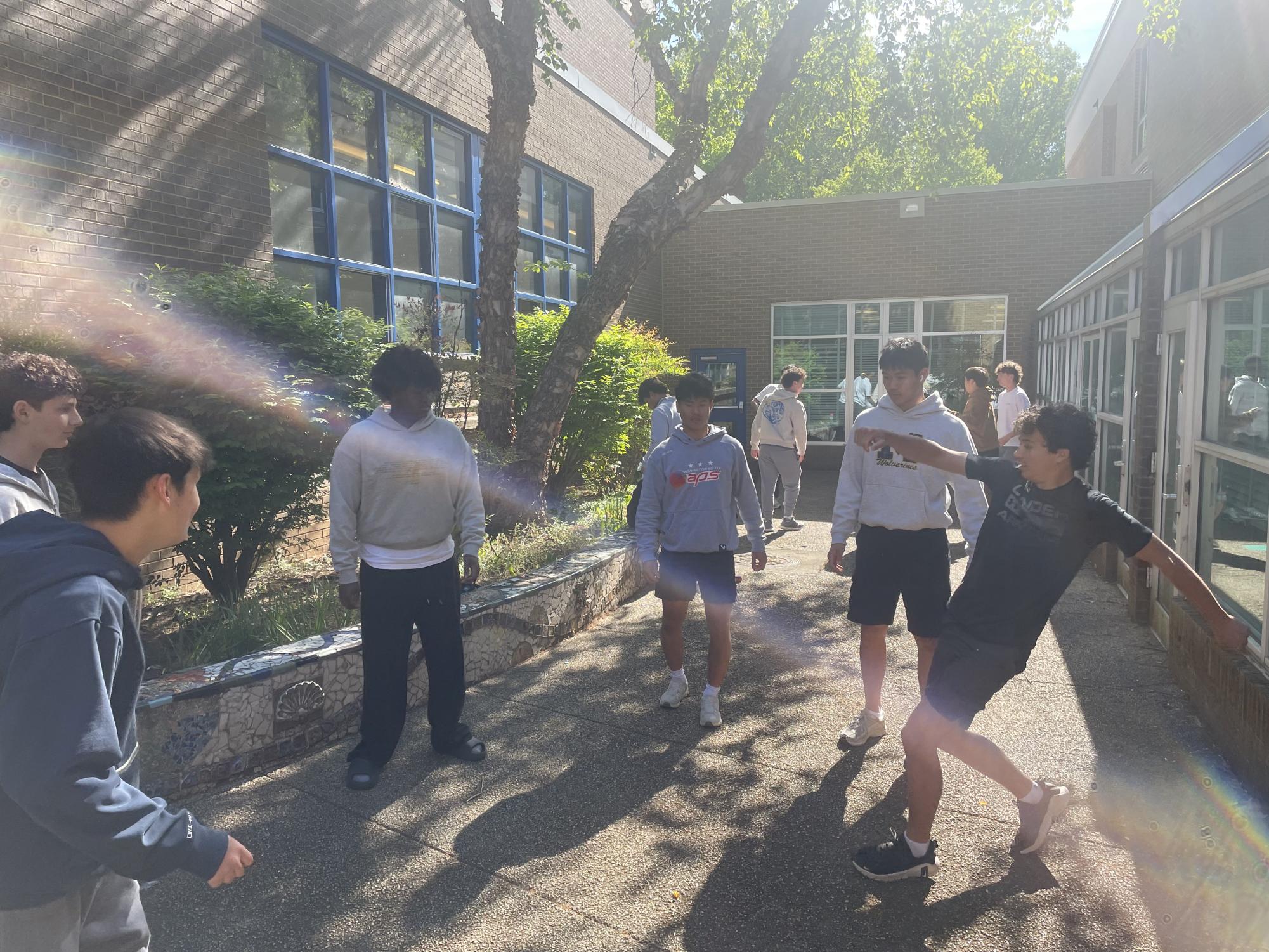 On Friday, May 1, juniors Blake Williams, Ben Reich, Musa Hussein, Evan Batbold, Max Lee and Henry Jacobs gather in the art courtyard to play hacky sack during the lunch period. "I love homeroom and lunch because that's when we 'sack,'" Williams said.