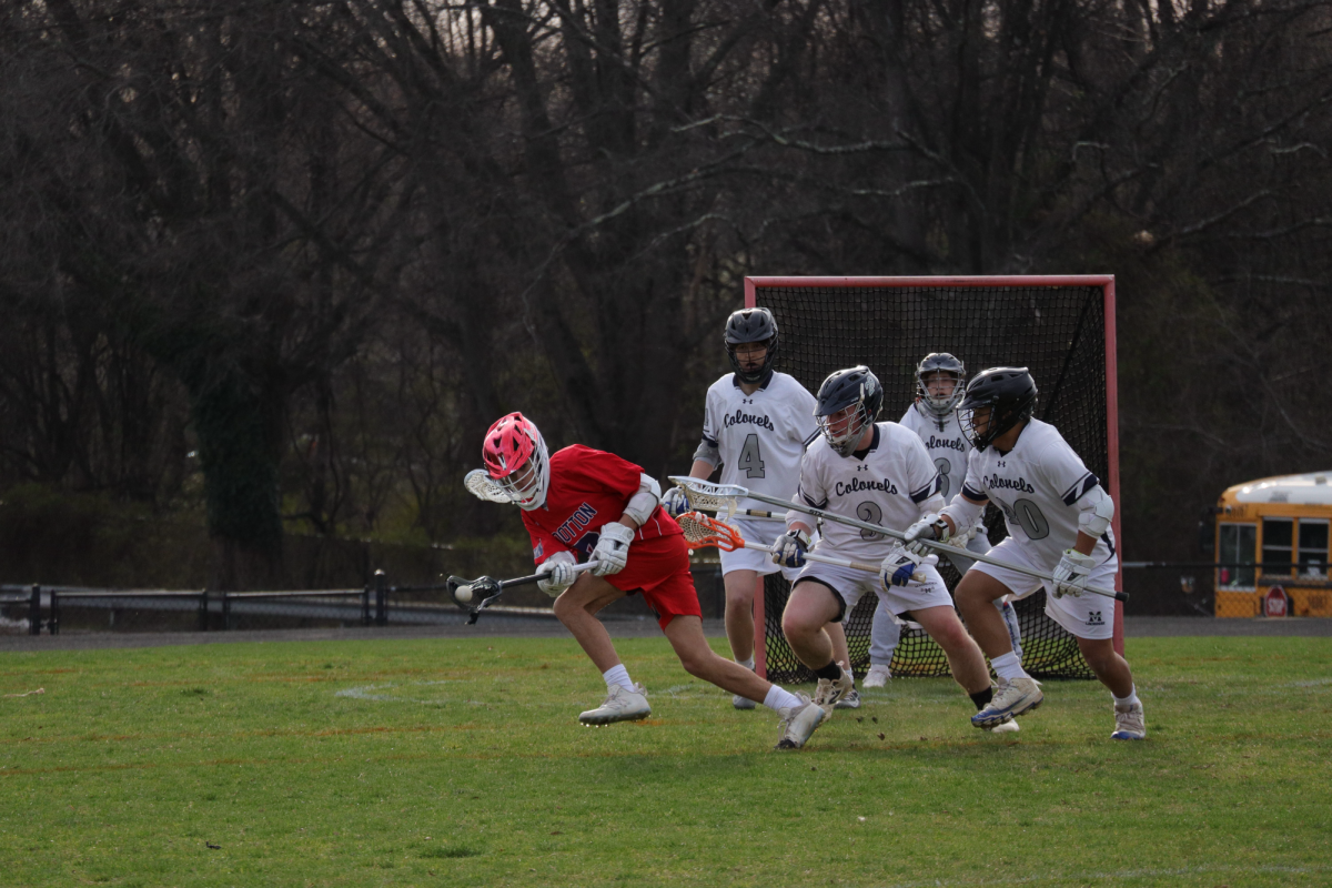 Sophomore Seth Childs secures a difficult pass with three defenders in his way, before scoring to end the game with a 6-3 win on March 25 against Magruder.
