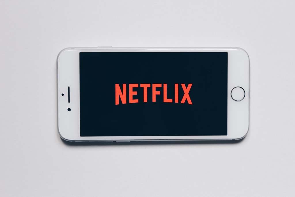After Netflix pioneered streaming, the way TV is watched changed dramatically. Because of Netflix's binge model they kept seasons shorter so audiences could get into shows and binge entire seasons faster. "netflix" by stockcatalog is licensed under CC BY 2.0.