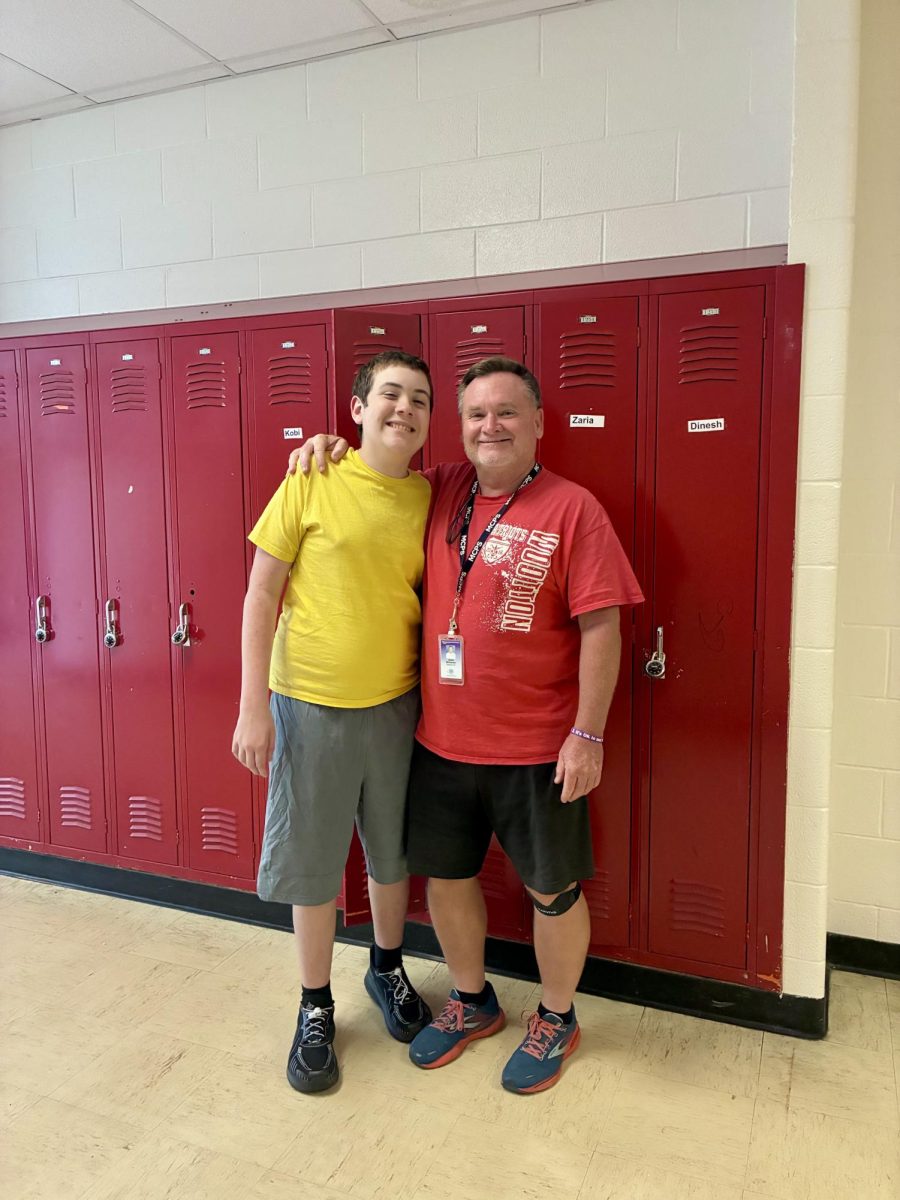 Paraeducator Jim Mckiernan supports student Hayden Fahlbusch after an afternoon activity.