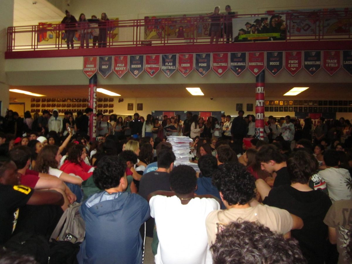 Hundreds of seniors come together for the paper toss on May 22, filling the Commons with excitement and school spirit. Photo by Kyle Li
